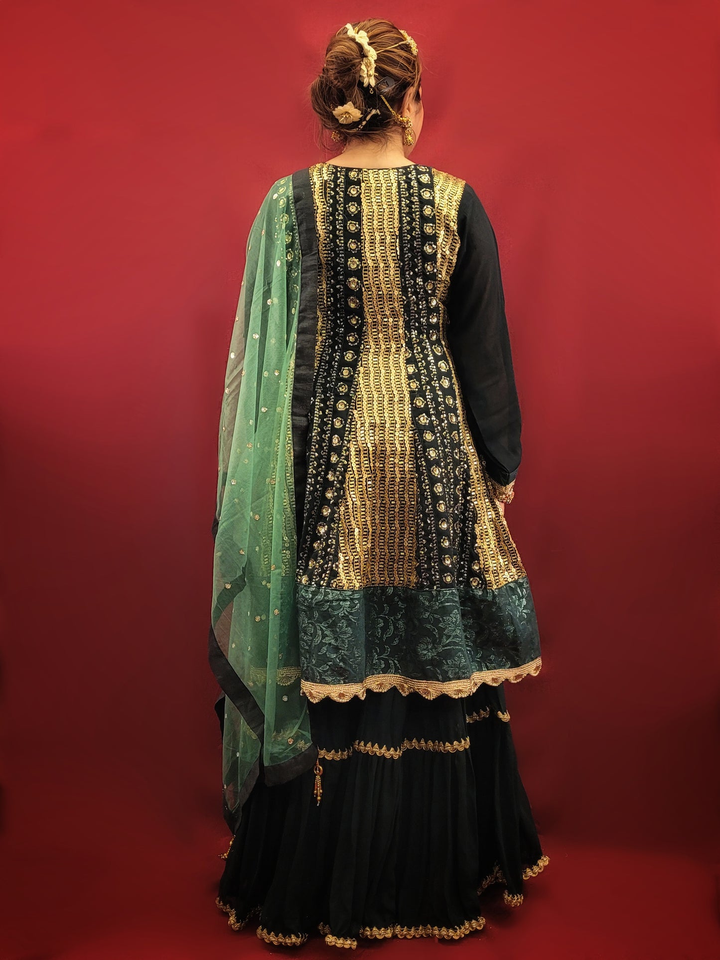 This Bottle Green Georgette Sharara Set features an elegant Angrakha Anarkali Kameez and a beautifully embroidered Net Dupatta. Made with high-quality materials, this set exudes sophistication and style. Perfect for any occasion, it offers both comfort and effortless elegance.