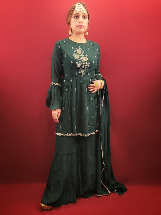 This green sharara, perfect for party wear, is gracefully embellished with a symphony of beads & pearls. It is an indo-western peplum matched with traditional flared sharara.