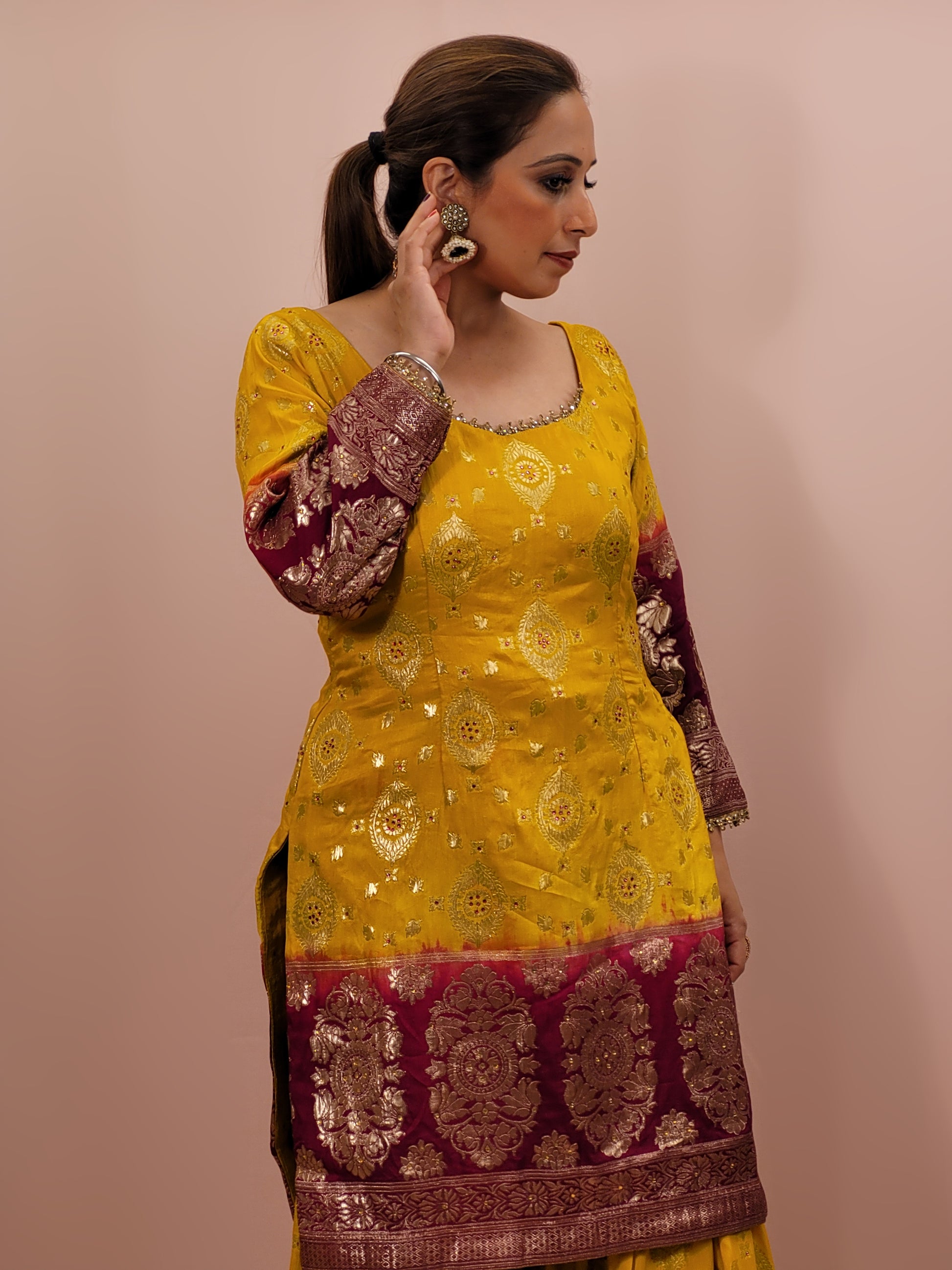 Step into the world of timeless elegance with this stunning Banarasi mustard yellow and maroon sharara suit. This exquisite ensemble is a perfect blend of traditional craftsmanship and contemporary design, making it an ideal choice for weddings, festivals, and special occasions.