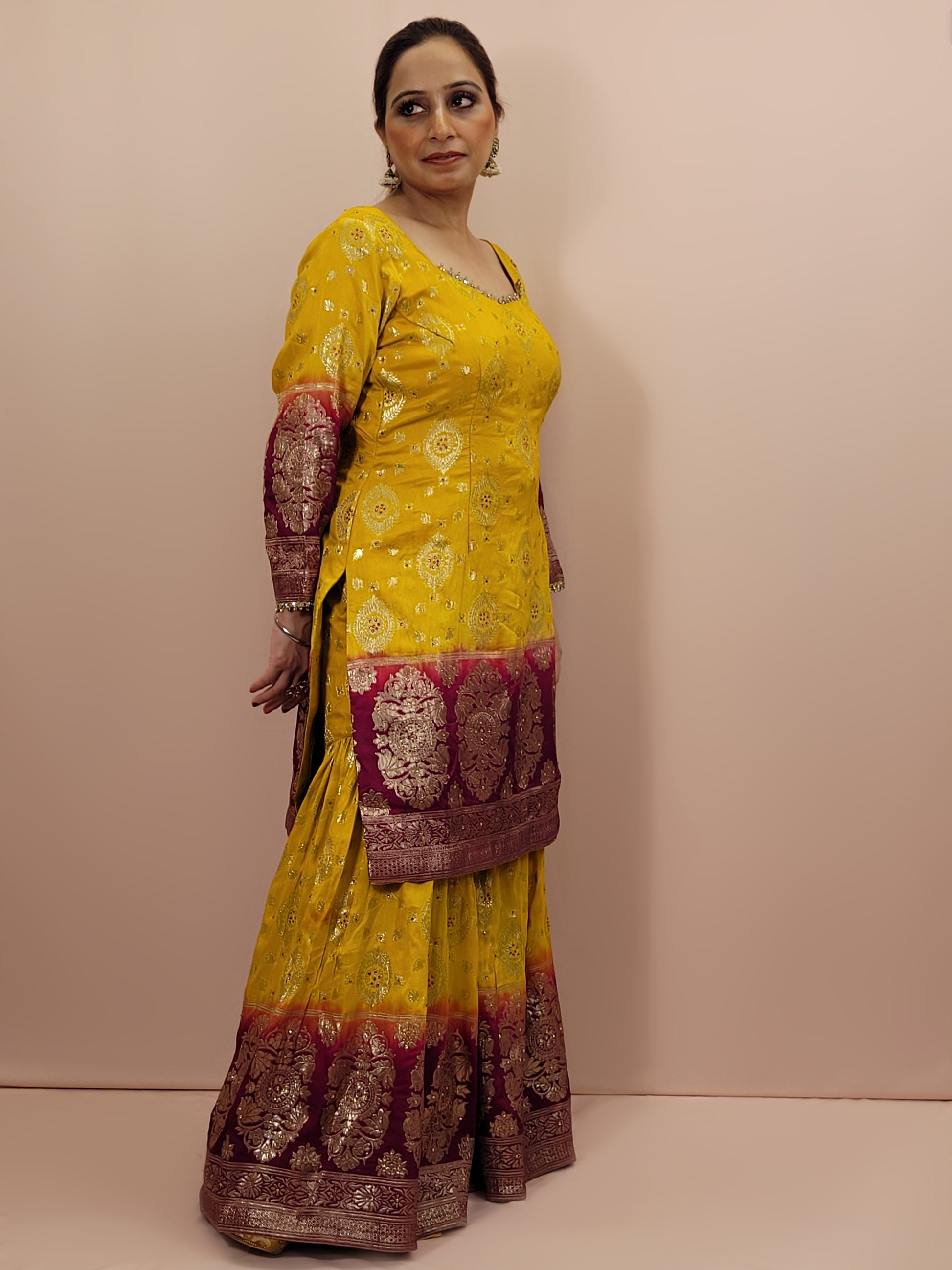 Step into the world of timeless elegance with this stunning Banarasi mustard yellow and maroon sharara suit. This exquisite ensemble is a perfect blend of traditional craftsmanship and contemporary design, making it an ideal choice for weddings, festivals, and special occasions.