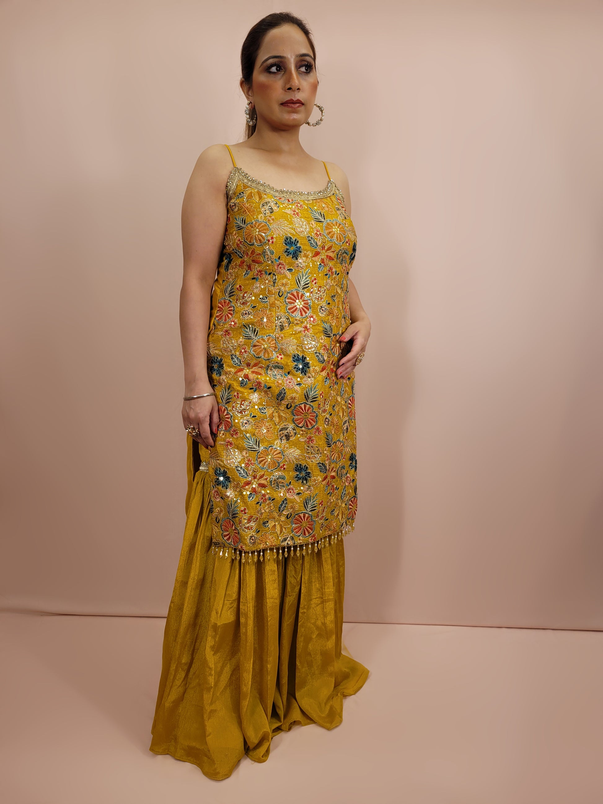 Step into the spotlight with our stunning Yellow Sharara Suit, crafted from luxurious chinnon fabric that offers a beautiful sheen and soft drape. This ensemble is perfect for festive occasions, weddings, and celebratory events, ensuring you stand out with grace and style.