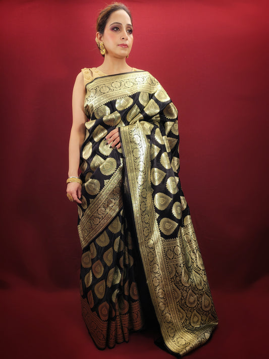 A black banarsi saree, crafted from pure banarsi silk, features intricate woven patterns, making it an elegant choice for party wear and Indian ethnic occasions.