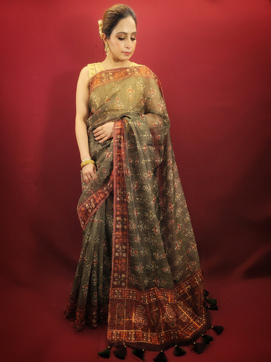 Embrace the grace of tradition with a mehendi green saree, adorned with exquisite organza and ajrakh prints, making it an ideal choice for party and festive wear.