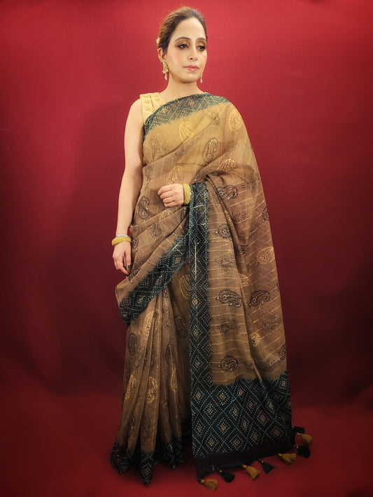 Step into the spotlight with a golden and green saree, featuring a bandhini print pallu on sheer organza, a stunning ensemble for any party or festive event.