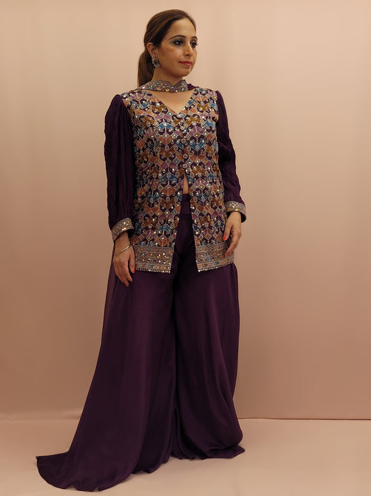 The mid-length shirt-style kameez features intricate multicolor resham embroidery, creating a tapestry of traditional artistry on the luxurious fabric. The sequins highlighting adds a touch of glamour, sparkling with every movement. The puffed full sleeves offer a modern silhouette that exudes sophistication. The palazzo pants are tailored to perfection, offering both comfort and style with their flowing georgette material. The matching dupatta drapes gracefully, completing the ensemble with finesse.