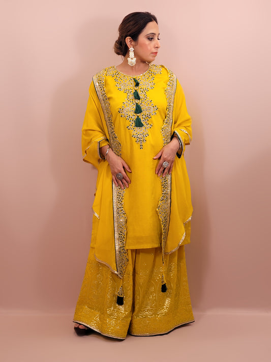 Yellow sharara suit with zari and resham neckline. Bichitra Silk Kameez. Georgette Shrug with Zari and Resham work border. Georgette Sharara wit Schiffli Work.