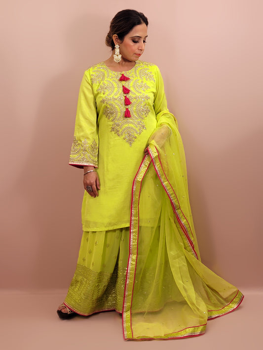 Green sharara suit with zari and sequins neckline. Bichitra Silk Kameez. Organza Dupatta with Border. Georgette Sharara with Schiffli Work. Fancy Sleeves Work.