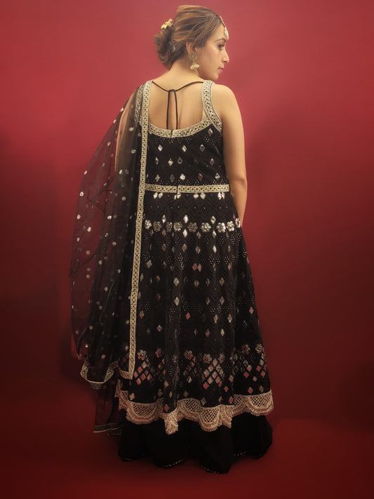 The black georgette sharara with an Anarkali, featuring foil mirror work, is a versatile ensemble that's ideal for a variety of occasions. It is perfect for weddings, festive celebrations, cocktail parties, and any event where Indian ethnic fusion is appreciated. It's elegance makes it a standout choice for making a sophisticated statement. 