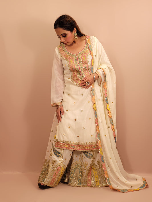 White Chinnon Pakistani Sharara Suit. Resham, Zari and Sequins work on Kameez, Sharara and Dupatta.