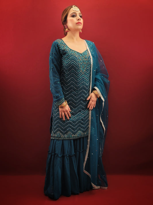 Prussian blue georgette kameez sharara set is the perfect choice for anyone looking for a stylish and elegant outfit for their next party or wedding event. The intricate cutdana, beads and zarkan work on the kameez and sleeves add a touch of glamour and sophistication to the overall design.